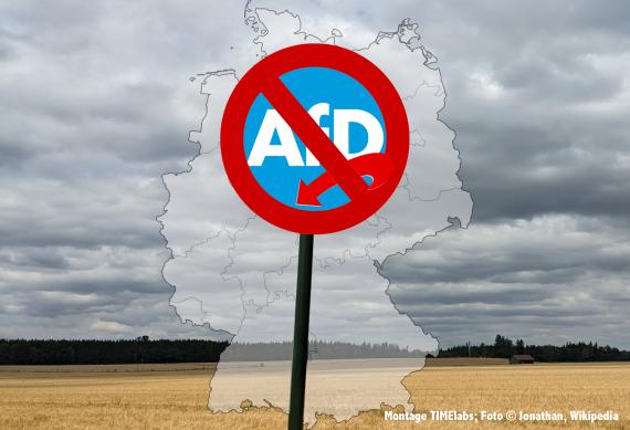 Deutschlandkarte vor Landschaft mit AfD-Verbotsschild